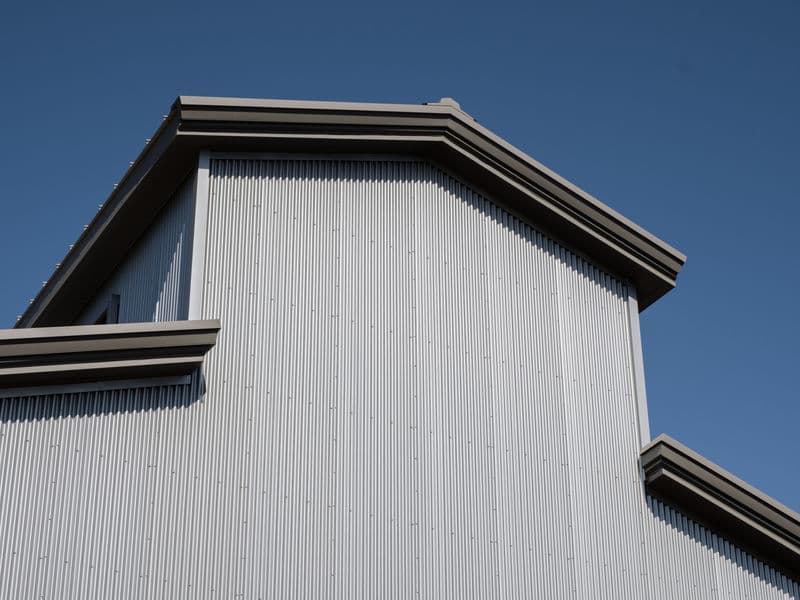 Galvalume AZ55 coated steel panel close-up showing metallic aluminum-zinc finish.